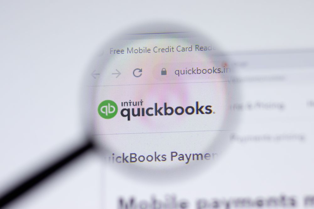 The Quickbooks logo is magnified through a glass.